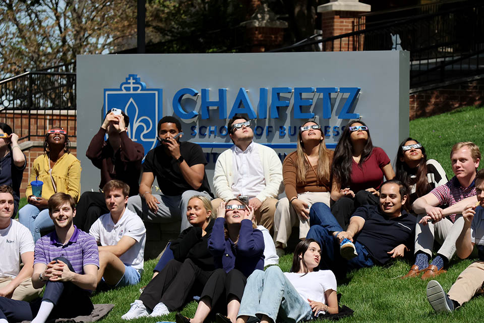 A crowd of watchers camped outside the Chaifetz School of Business at pro to catch a glimpse of the solar eclipse on Monday, April 5. Photo by Joe Barker. 
