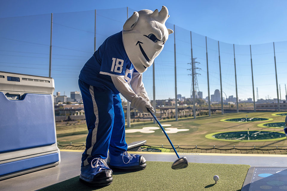The Billiken tees off at the new Topgolf St. Louis Midtown after the ribbon-cutting ceremony on Friday, Oct. 20. 