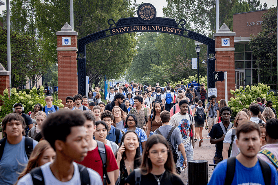 Students walk to class on a sunny day on pro's campus.